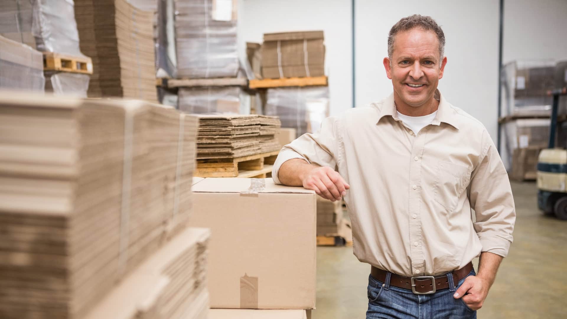 Manufacturing plant worker reviewing production paperwork