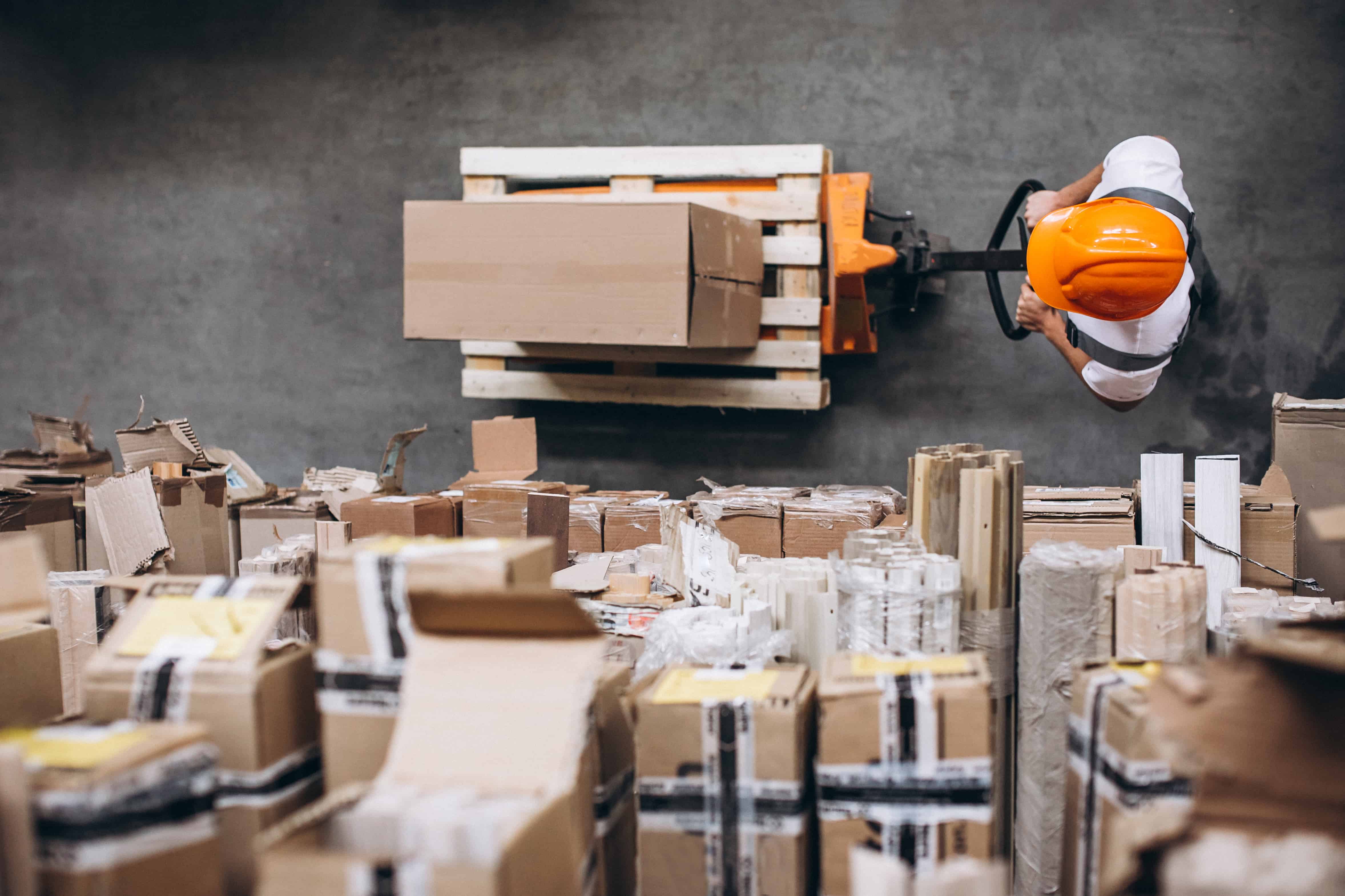 Wholesale distribution worker managing boxes in a warehouse