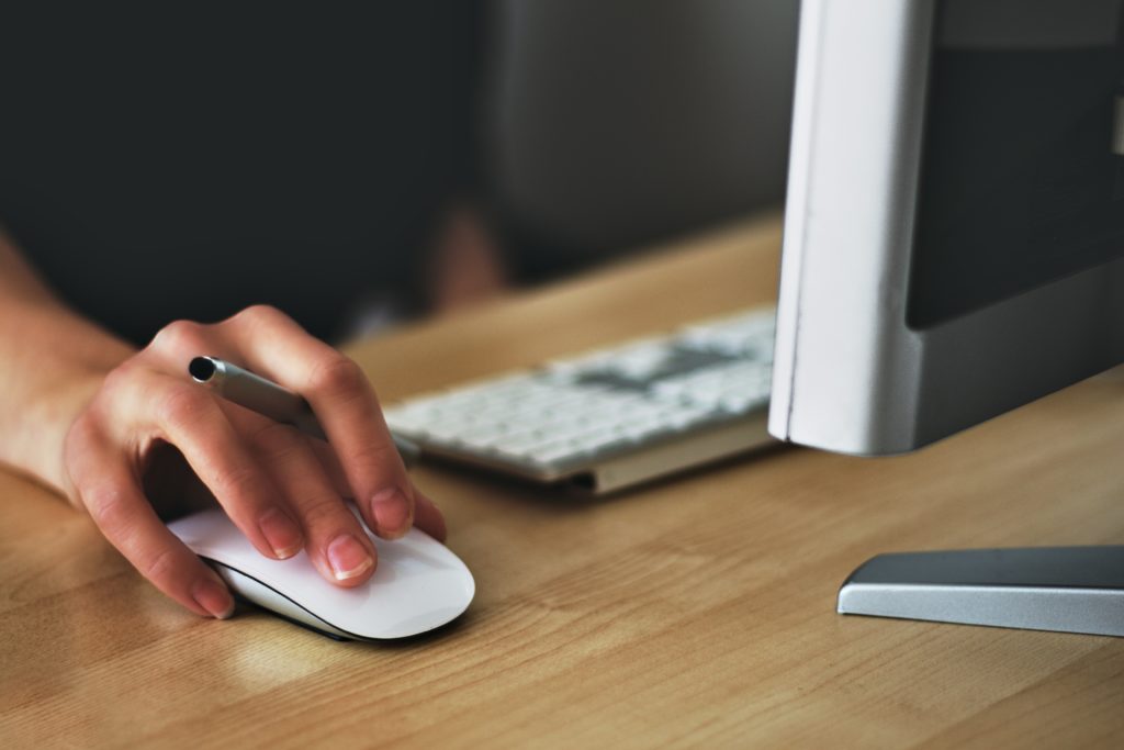 small business loans online; person using computer mouse