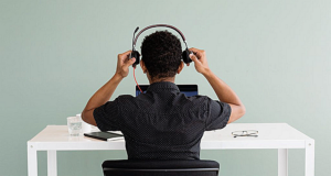 factoring relationship; Man putting on headset at call centre