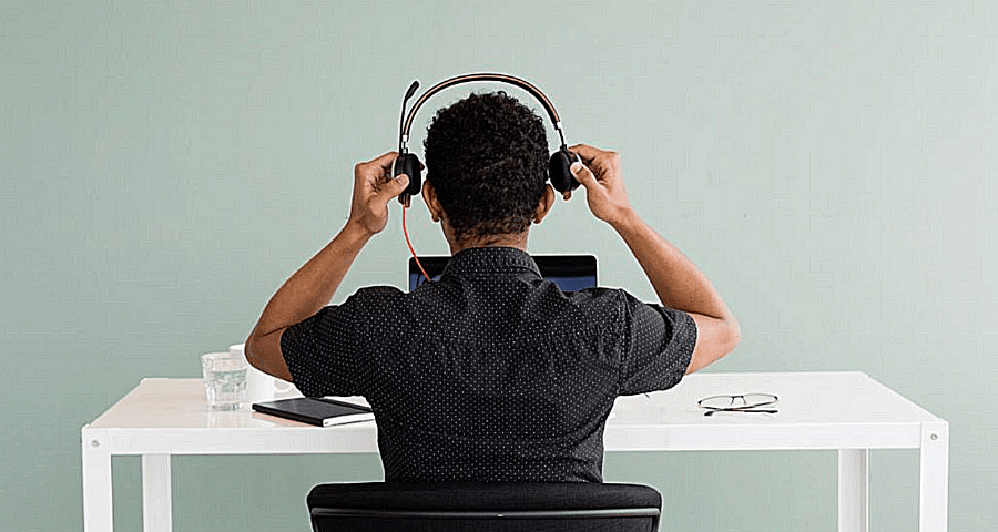 Man putting on headset at call centre