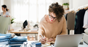 Female retail business owner using a laptop