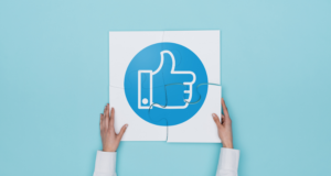 Social media marketing strategy- Person holding up a 'like' sign