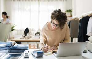 Female retail business owner using a laptop