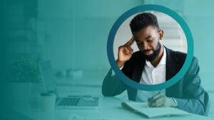 Man working at desk with pen and paper