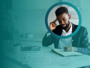 Man working at desk with pen and paper