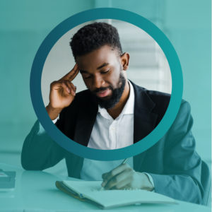 Man working at desk with pen and paper