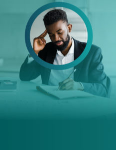 Man working at desk with pen and paper