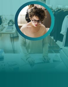 Woman working in clothing shop using a laptop