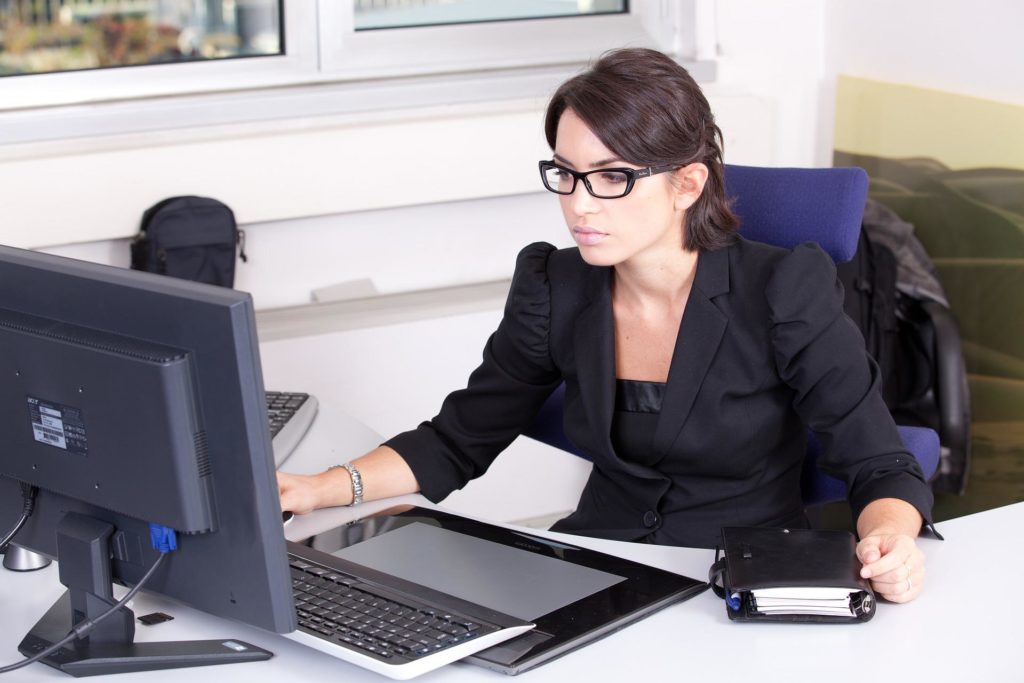 QuickBooks capital marketplace; woman sitting at desk looking at computer