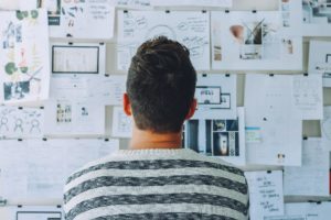 oil and gas startup funding; person looking at business planning board
