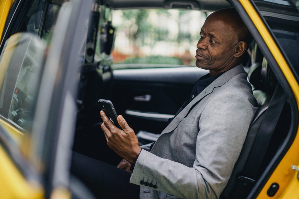 what is embedded finance?; man in a taxi holding cell phone